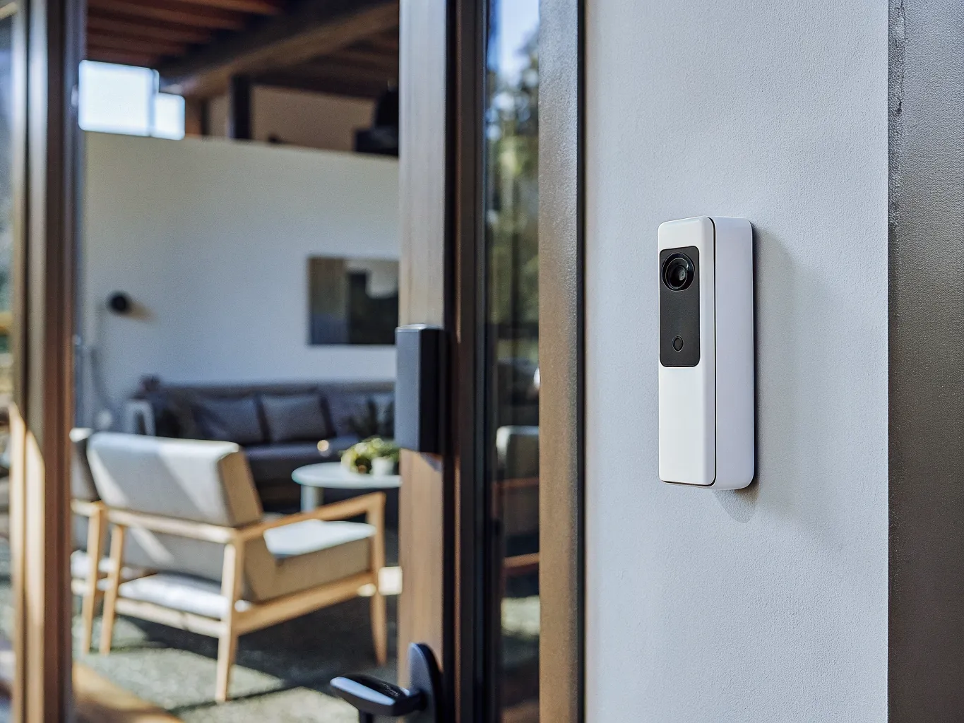 Smart doorbell camera mounted next to a modern home entrance