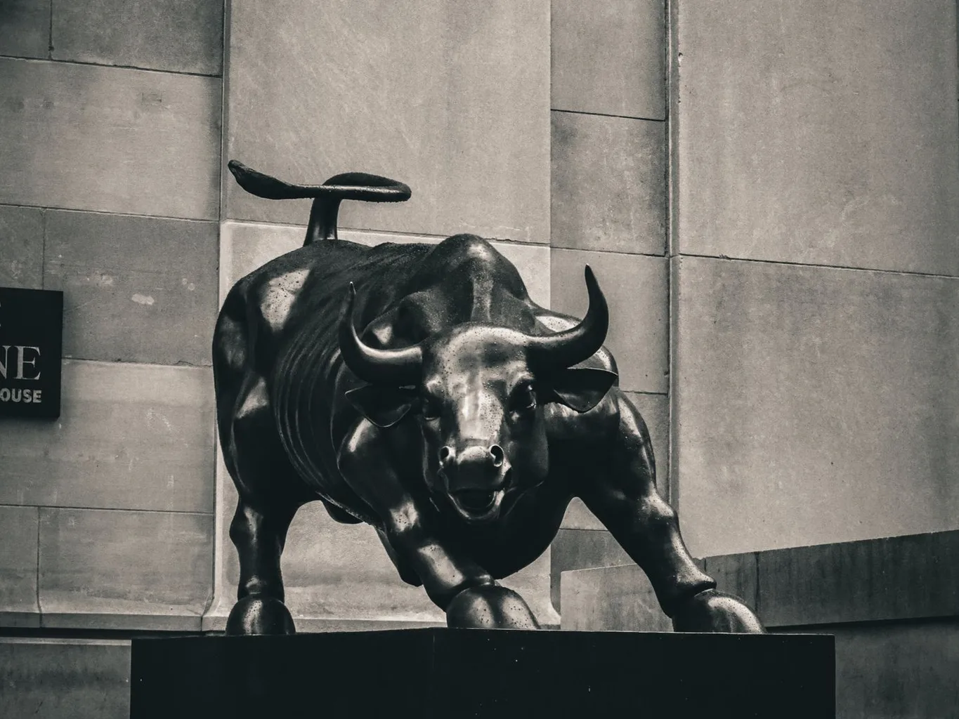 The bronze Charging Bull statue near Wall Street, in black and white