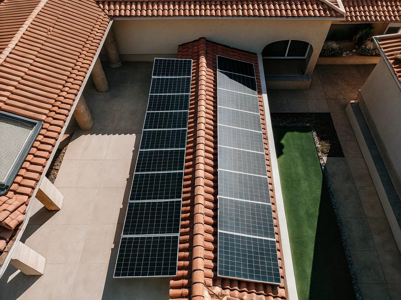 Solar panels on a modern suburban house rooftop at golden hour